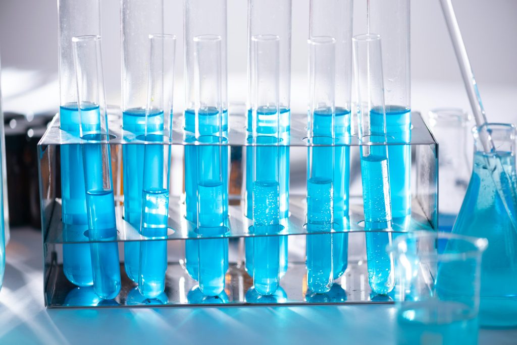 pexels-photo-2280549-2280549-1 Close-up of blue liquid in test tubes for chemistry experiments in a laboratory setting.